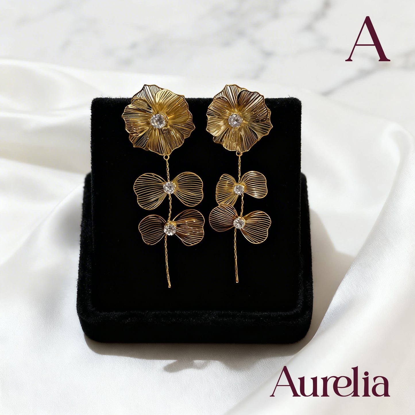 ARETES FLOR BRILLANTE Y DOBLE MOÑO