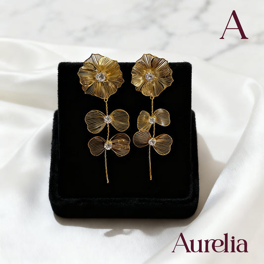 ARETES FLOR BRILLANTE Y DOBLE MOÑO
