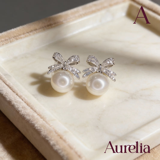 ARETES MOÑO BRILLANTE Y PERLA BLANCA GRANDE