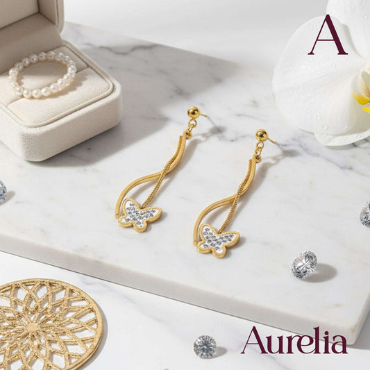 ARETES LARGOS MARIPOSA DETALLE PLATEADO