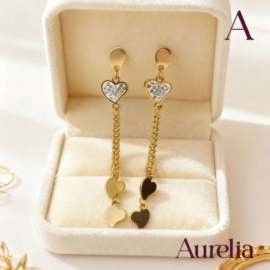 ARETES LARGOS CORAZON CON BRILLANTE PLATEADO Y MINI CORAZONES