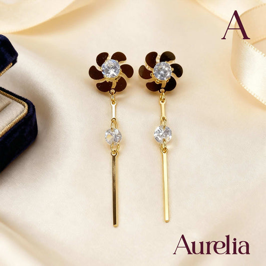 ARETES LARGOS FLOR Y PALO DETALLE PLATEADO